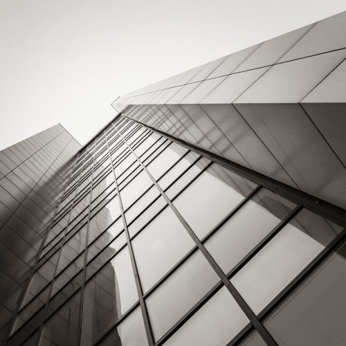 a modern building, a fragment of a skyscraper. A perspective that goes up into the sky. Sepia tinting. architecture, design, and geometric lines.